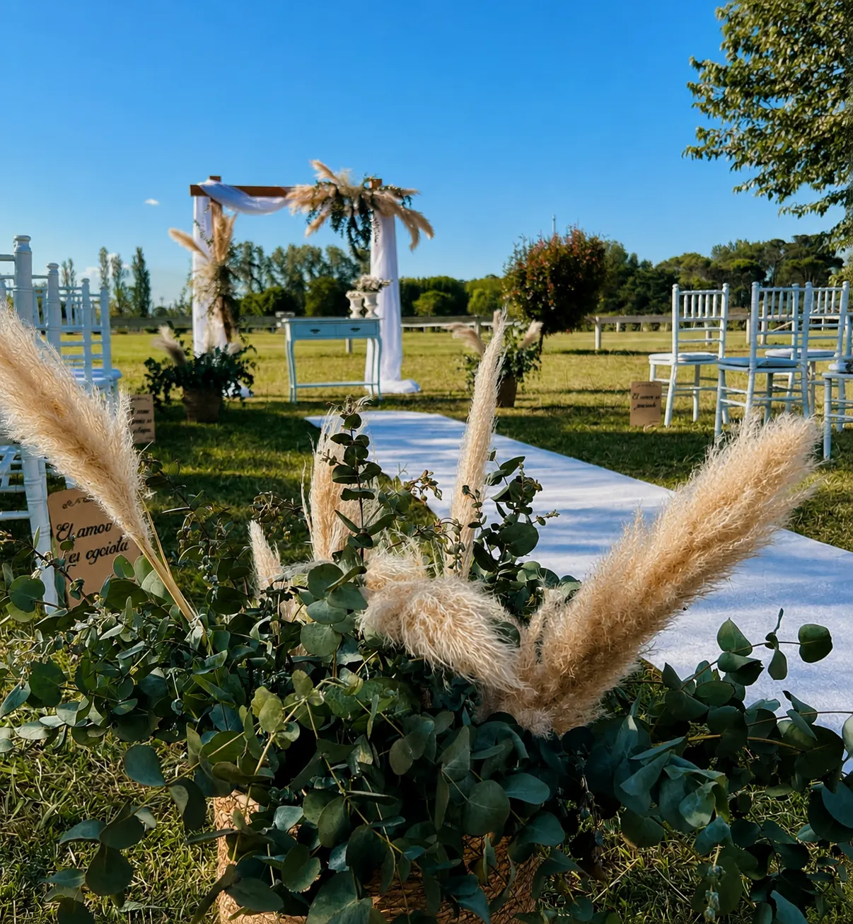 Arco de ceremonia con pampas y flores blancas en un evento al aire libre organizado por Ambientaciones ML
